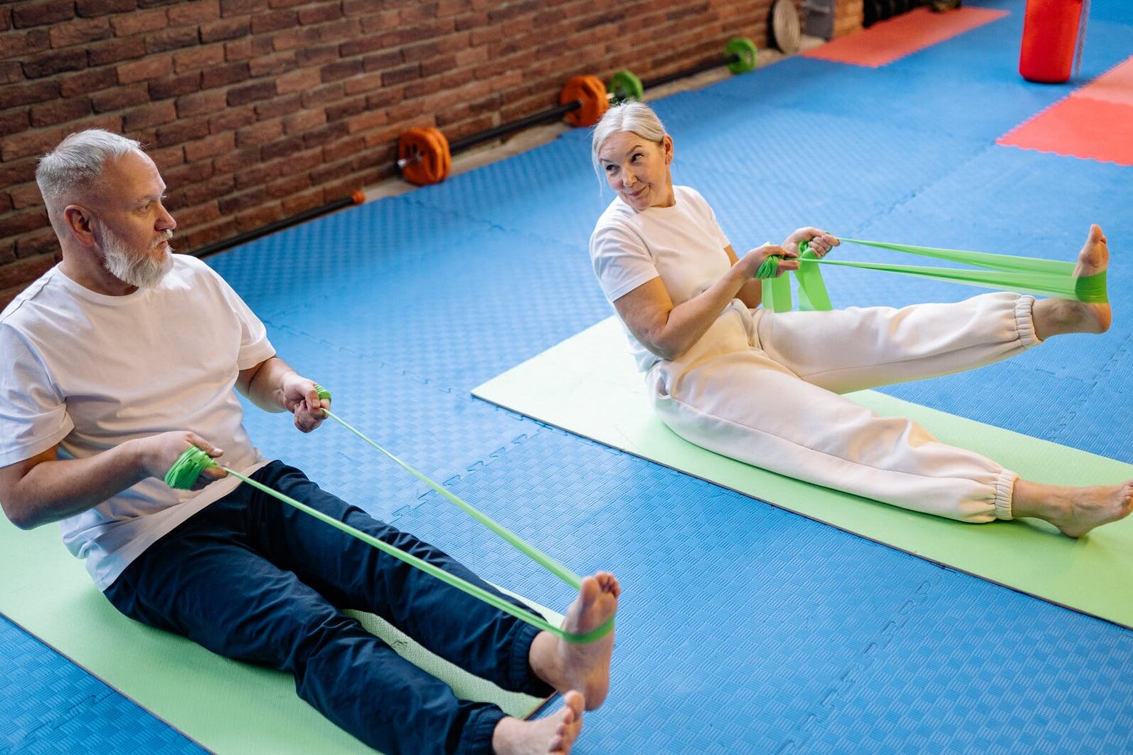 a couple exercising with resistance bands