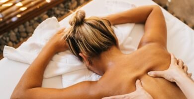 a massage therapist massaging a client s back
